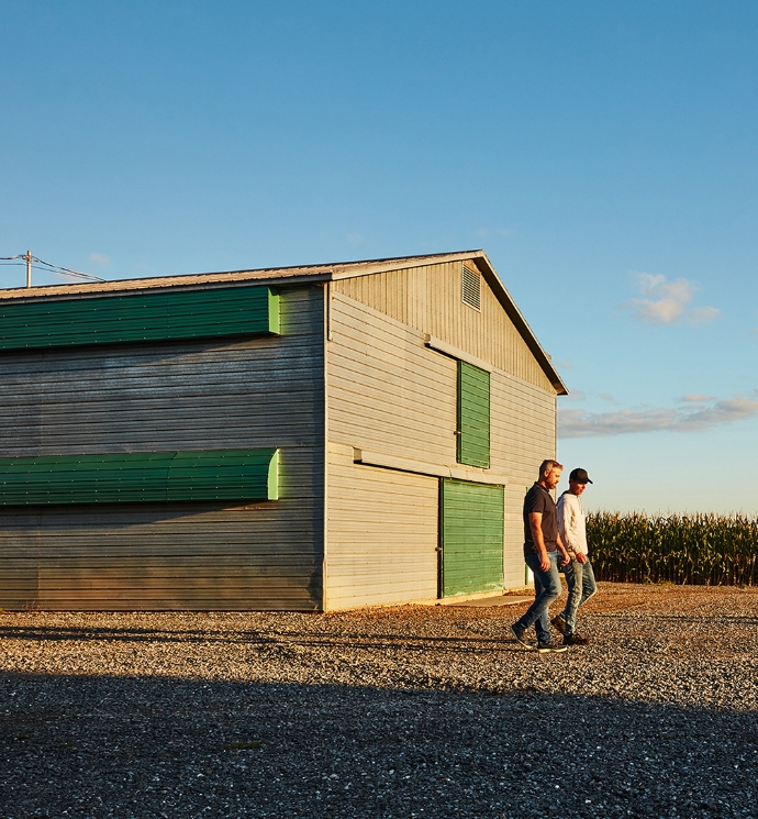 Two men walking on their farm